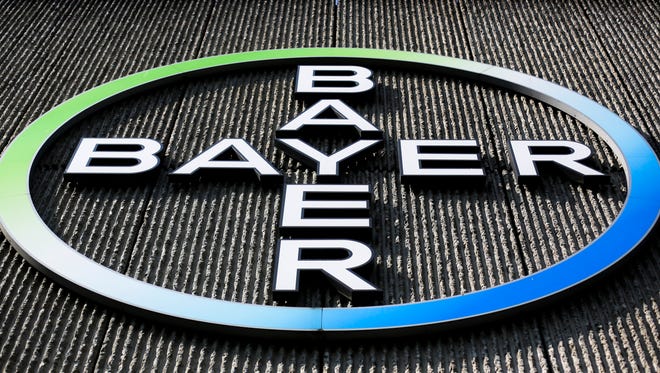 FILE - This Monday, May 23, 2016, file photo, shows the Bayer AG corporate logo displayed on a building of the German drug and chemicals company in Berlin.  The German pharmaceutical giant has agreed, Tuesday, May 29, 2018,  to the U.S. government's demand that it sell about $9 billion in agriculture businesses as condition for acquiring Monsanto Co., a U.S. seed and weed-killer maker. Antitrust regulators at the Justice Department say it's the biggest divestiture ever required for a merger.
