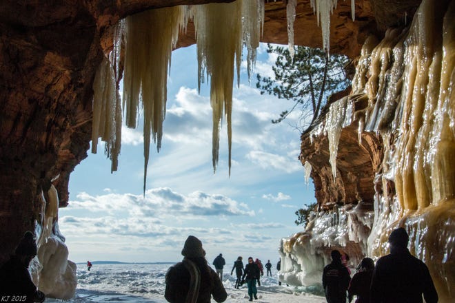 2014. Lucky visitors take in the spectacular beauty of the Apostle Island ice caves that can only be opened to the public when temperatures have been cold enough for Lake Superior to freeze.