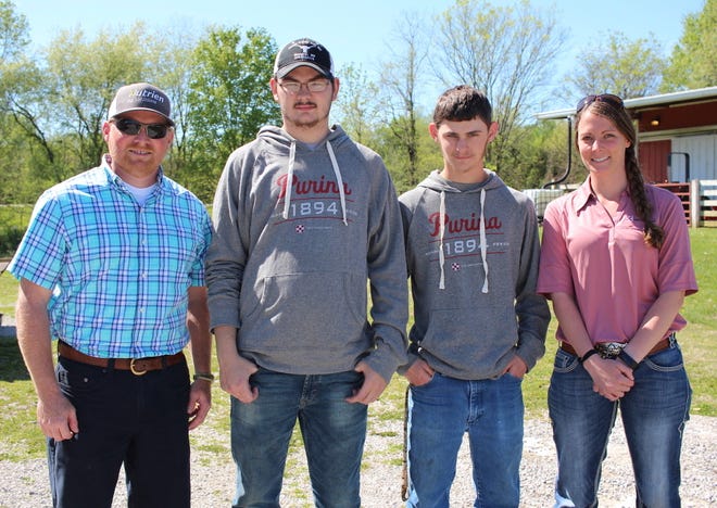 From left, Andy Moore, Barren County High School agriculture teacher; BCHS juniors Donovan London and Daylin Posey; and Katie Carrier, mid-atlantic division livestock production specialist for Purina Animal Nutrition, pose outside of BCHS, April 22, 2019, in Glasgow, Ky. BCHS agriculture students recently helped conduct a 28-day feed trial with Purina Animal Nutrition.