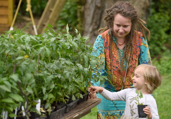 In a May 18, 2019 photo, Paige Barocca, of Glendale, and her daughter Clementine, 4, shop at Moon Valley Farm's plant sale in Cockeysville, Md.