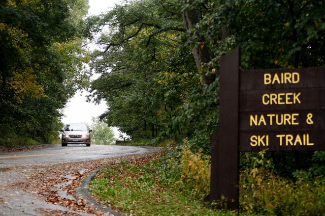 Cars drive in the rain on Tuesday, Oct. 1, 2019, near Baird Creek Nature and Ski Trail in Green Bay, Wis. Green Bay received 0.55 inch of rain as of 3 p.m. Oct. 1, breaking the record for the most precipitation in a year. That record was set in 2018.