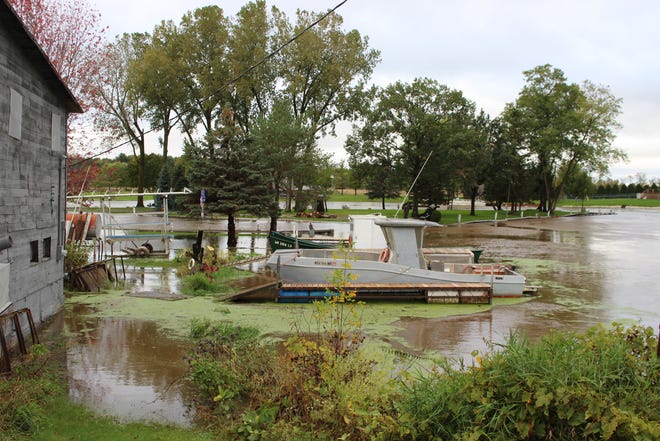 The Suamico River floods on Wednesday, Oct. 2, 2019, along Riverside Drive in Suamico.