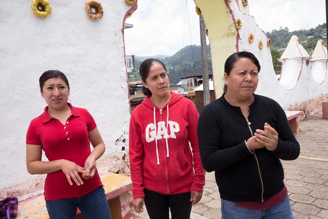 Blanca Hernández, center, walks with friends Lucero Quechulpa, left, and Fátima Anastasio in Texhuacán. The three worked at dairy farms in Wisconsin or Minnesota before returning to México.