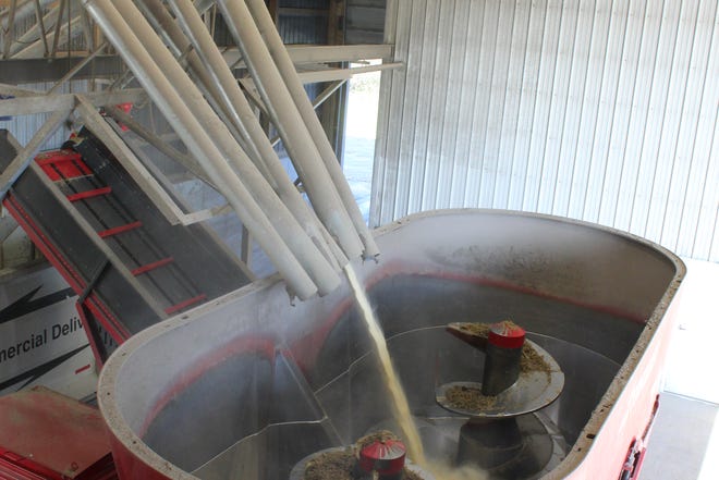 Feed ingredients are dispersed into the Trioliet stationary mixer inside the Feed Center at Vir-Clar Farms.