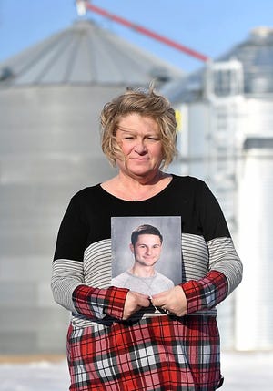Michele Gran, shown here holding a photo of her 18-year-old son, Landon on her family's farm near Norseland, Minn., plans to advocate for more safety features in and around grain bins this legislative session after  Landon, died in August inside a grain bin two miles south of his home in Norseland. Landon is one of at least nine people who died in grain bin-related incidents since July.