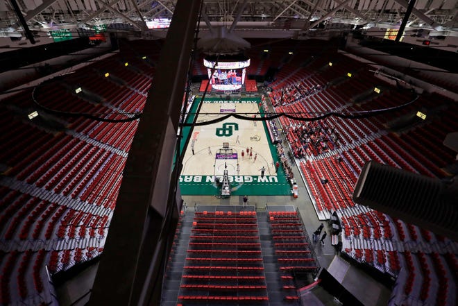 The stands are mostly empty as Arcadia plays Platteville during a Division 3 semifinal game Thursday at the WIAA girls state basketball tournament at the Resch Center in Ashwaubenon.