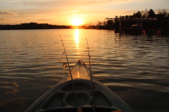 The sun rises over Beaver Lake in Hartland on Saturday, opening day of the general Wisconsin fishing season.