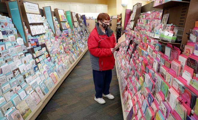 Janice Kocinski looks for a card at Winkie's Hallmark and Gifts in Whitefish Bay on Tuesday.   As of May 11, standalone or strip mall-based retail stores can offer in-person shopping, as long as customers are limited to five at a time and social-distancing guidelines are followed, Gov. Tony Evers announced Monday.
