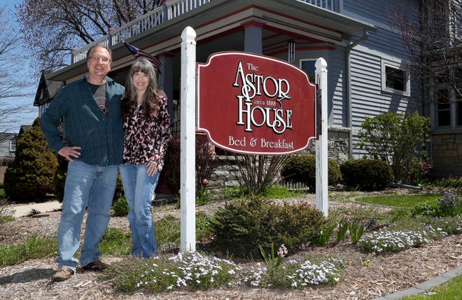 Tom and Linda Steeber, owners of The Astor House Bed & Breakfast, stand outside their property on May 12, 2020, in Green Bay, Wis.