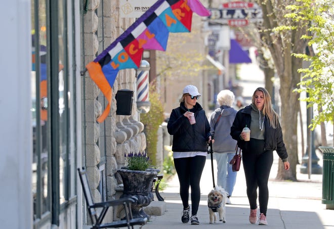 Amanda Wesenberg, left, ￼of Menomonee Falls and Michelle Vogds of Brown Deer walk along Washington Avenue in Cedarburg on Wednesday.  As of Monday, stand-alone or strip mall-based retail stores can offer in-person shopping, as long as customers are limited to five at a time and social-distancing guidelines are followed, Gov. Tony Evers announced.