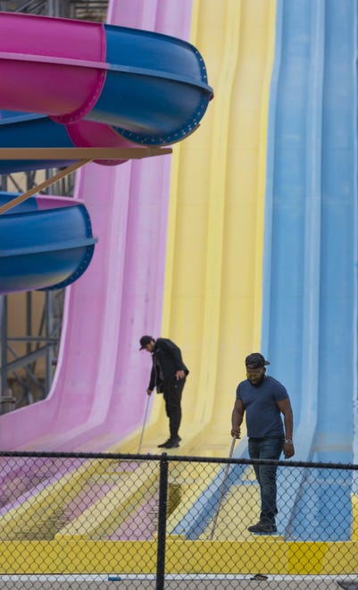 Workers clean a water slide at Mt. Olympus Water and Theme Park in Wisconsin Dells. Wisconsin Dells water and amusement parks are gearing up to reopen after the state Supreme Court overturned Gov. Tony Evers' safer-at-home order.