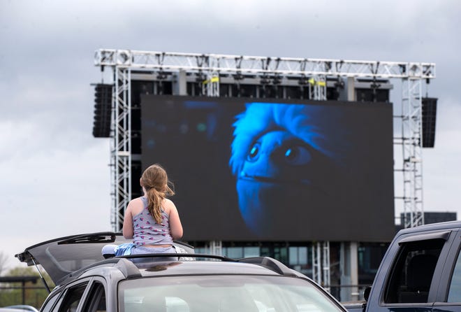 Audriana Coleman, 8, watches " Abominable " on the top of a car on in Franklin at The Milky Way Drive-In. The drive-in opened for the season on Memorial Day weekend with some guidelines for social distancing.