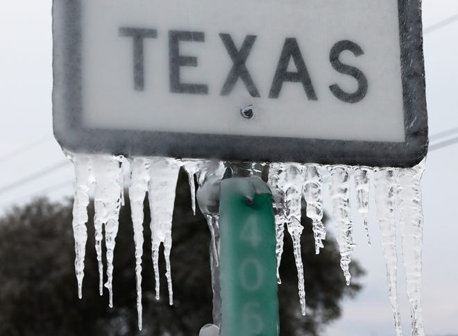 Icicles hang off the  State Highway 195 sign on Feb. 18 in Killeen, Texas. Winter storm Uri brought historic cold weather and power outages to Texas.
