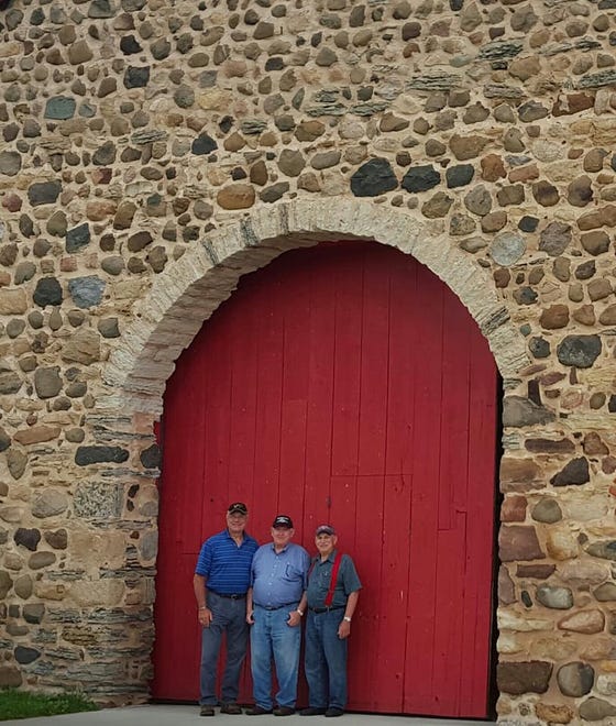 The 14-foot tall arched doorway dwarfs these men.