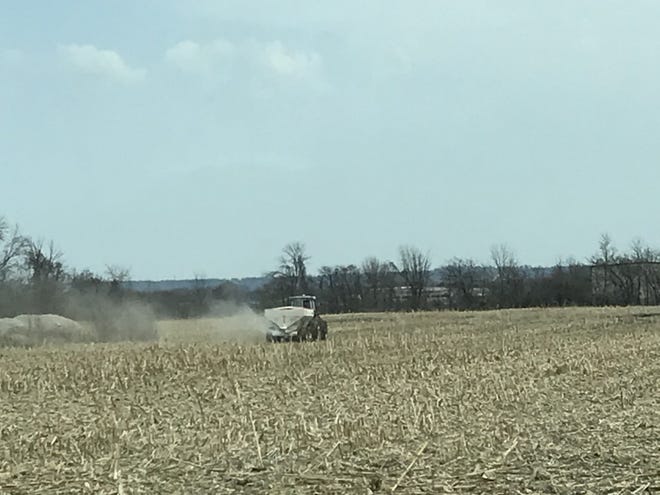 A farmer spreads fertilizer on a field near Fond du Lac County on April 5, 2021.